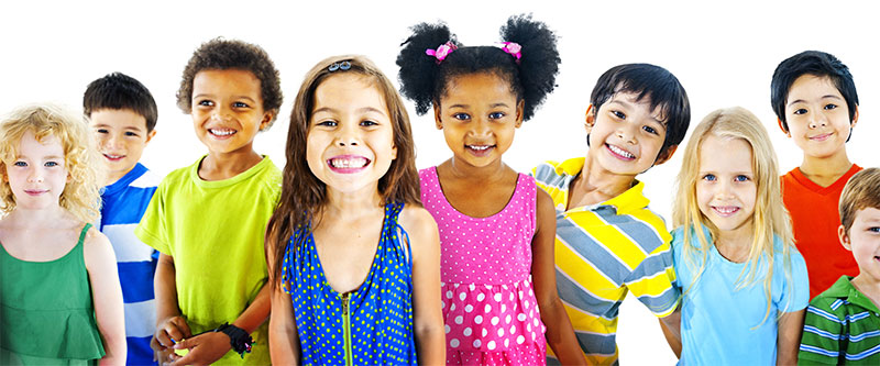 A group of diverse children smiling at the camera, with various colors in their clothing.